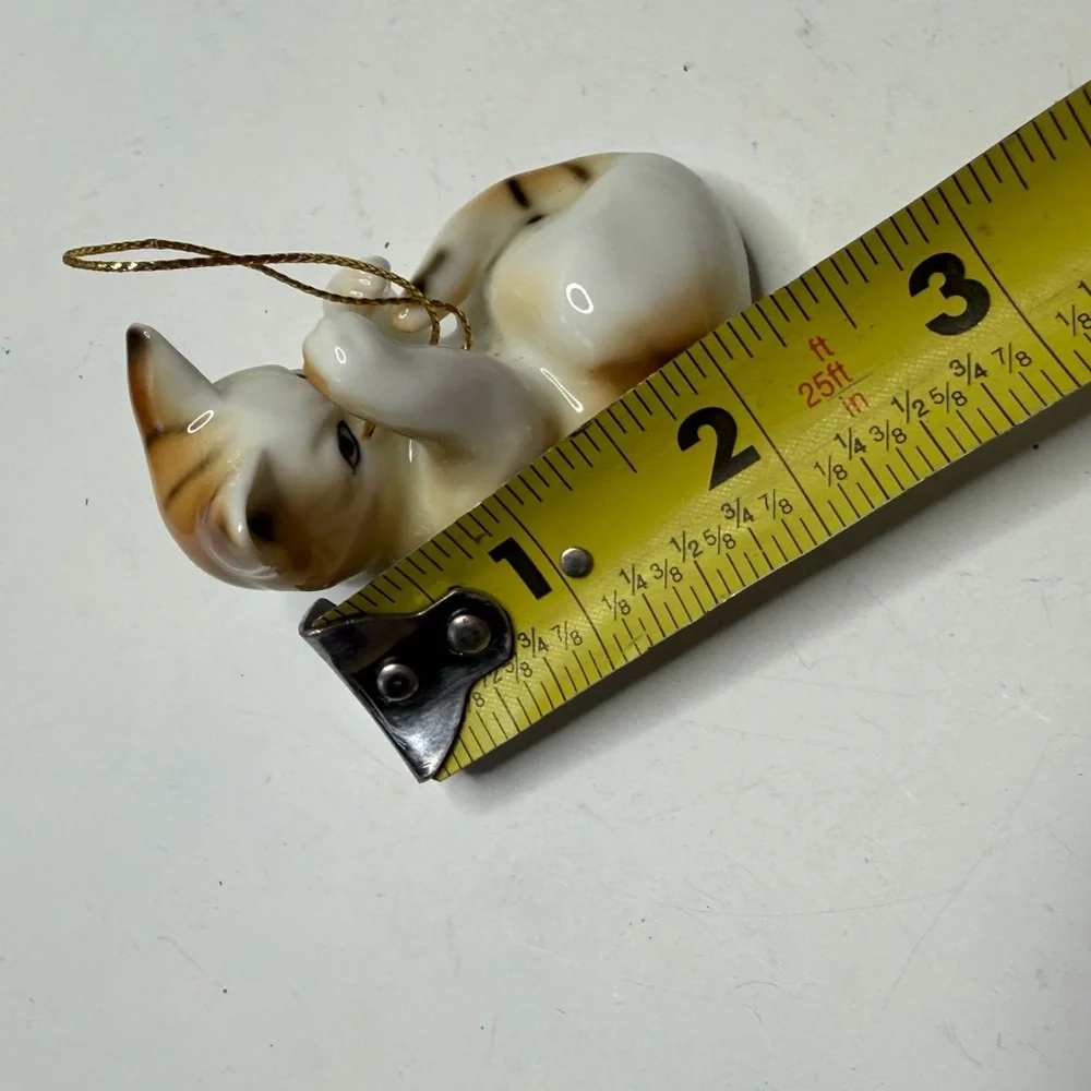 Decorative White and Tan Ceramic Cat Ornament with Red Bow